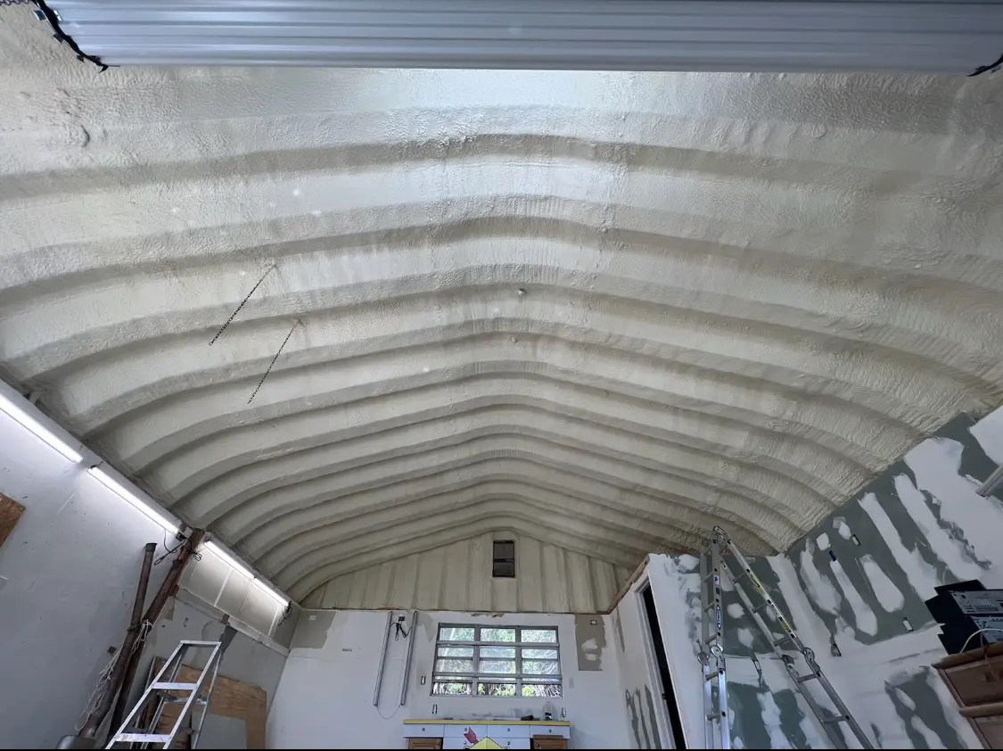 Spray polyurethane foam applied to the underside of a metal roof deck in Los Banos